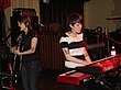 Two women with black hair singing