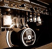 Rear view of a tube (valve) combo guitar amplifier. Visible are two glass output tubes, six smaller preamp tubes in their metal tube retainers, and both the power transformer and the output transformer. Trace Elliot Bonneville rear view.jpg