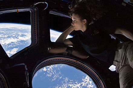 Astronaut Tracy Caldwell Dyson "Earth gazing" in the Cupola module of the International Space Station, a practice found to have positive psychological effects, one that is especially important in coping with the demands of spaceflight.[4]