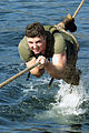US Marine Corps Reserve (USMCR) Lance Corporal (LCPL) Elliot Danish, Rifleman, Kilo Company (K CO), 3rd Battalion, 25th Marines (3-25), pulls himself across a rope line over water as he finishes the cat crawl as 040130-M-UW798-043.jpg