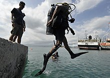 Stride entry or front step entry from a low dockside US Navy 110727-N-KB666-379 Arnulfo Lopez conducts a front step entry prior to search operations with Mobile Diving and Salvage Unit (MDSU) 2.jpg