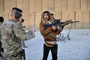 Alicia Fox receiving instruction on firing a gun during the Tribute to the Troops 2016 tour. WWE in Afghanistan 001.jpg