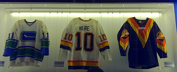 Bure's first game-worn Canucks jersey (centre) on display at Rogers Arena (also pictured on either side are Wayne Maki and Glen Hanlon's jerseys).