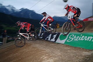 Four-cross style of mountain bike racing where four bikers race downhill on a prepared BMX-like track