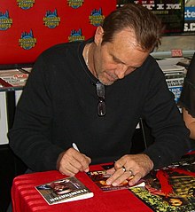 Cast member Michael Biehn signing the cover of the film on DVD in 2012