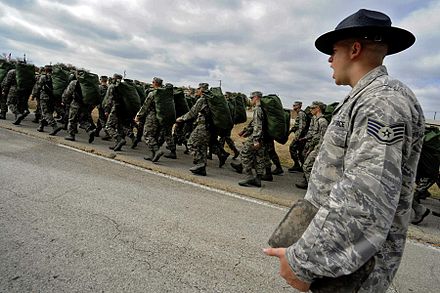 An MTI marching his unit following the issuance of uniforms and gear
