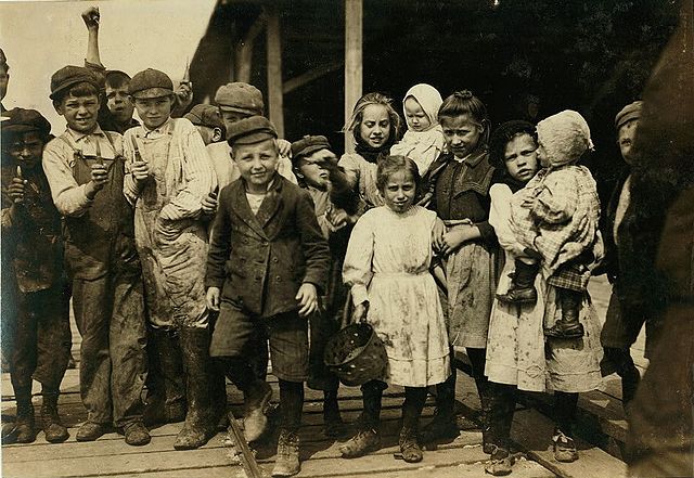 Children employed as oyster shuckers at Pass Packing Company, 1911. Photo by Lewis Hine.