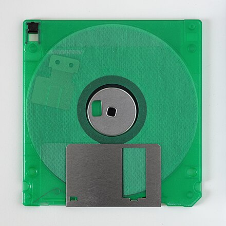 Rear side of a 3½-inch floppy disk in a transparent case, showing its internal parts