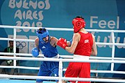 Deutsch: Boxen bei den Olympischen Jugendspielen 2018 Tag 12, 18. Oktober 2018 - Kampf um Bronze im Leichten Weltergewicht Jungen – Hassan Azim (Großbritannien, rot) schlägt Mohammed Boulaouja (Marokko, blau) RSC; Ringrichter ist Wulfren Olivares Peréz (Kolumbien). English: Boxing at the 2018 Summer Youth Olympics on 18 October 2018 – Bronze Medail Match Light Welterweight Boys - Hassan Azim (Great Britain, red) beats Mohammed Boulaouja (Morocco, blue) RSC; Referee is Wulfren Olivares Peréz (Columbia). Español: Boxeo en los Juegos Olímpicos Juveniles de Verano de 2018 en 18 de octubre de 2018 - Medalla de bronce de los hombres ligeros de peso welter: Hassan Azim (Gran Bretaña, rojo) vence a Mohammed Boulaouja (Marruecos, azul) RSC; El árbitro es Wulfren Olivares Peréz (Colombia).