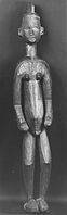Figurină ce datează din sfârșitul secolului al XIX-lea sau de la începutul secolului al XX-lea. Ea este expusă la Brooklyn Museum din New York, Statele Unite ale Americii. Figurina are o înălțime de 165,6 centimetri.