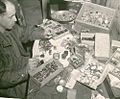 An American soldier examining various valuables stolen from prisoners of Buchenwald by Nazis