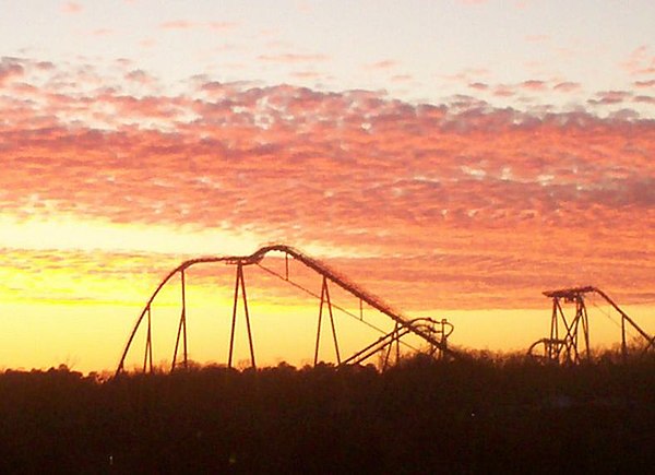 On the western edge of Grove, a winter sunset silhouettes several of the roller coasters at the Busch Gardens Williamsburg theme park.