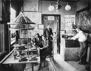 Photograph of Charles Herrold's San Jose California radio laboratory, circa 1912. Herrold is standing in the doorway. Charles Herrold laboratory circa 1912.jpg