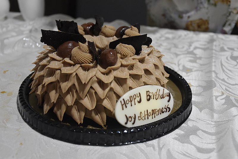 File:Chestnut Cream Cake with Happy Birthday Joy and Happiness sign.jpg