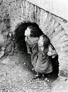 Girls hiding during a Nationalist bombing of Madrid in 1937. Children during the Madrid bombing.jpg