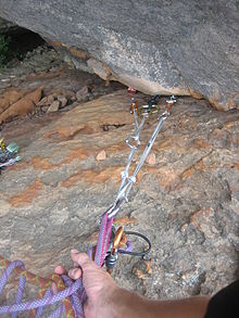A climbing anchor; in this example, all three pieces are placed in the same crack. Generally, anchor pieces should be placed in different features, where possible, to protect against rock failure. Climing anchor.JPG