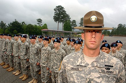 A U.S. Army drill sergeant standing before his company.