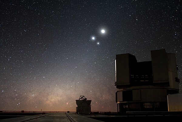 In the night sky over ESO's Very Large Telescope (VLT) observatory at Paranal, the Moon shines along with two bright companions: Venus and Jupiter.