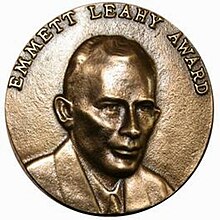A plaque bearing Medallion with an embossed image of Emmett Leahyl facing right in profile.
