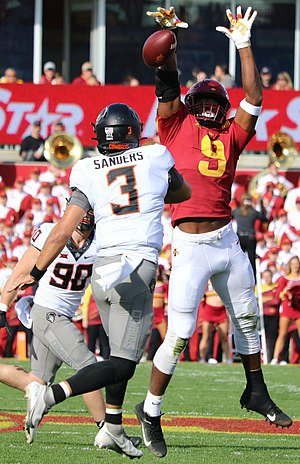 Iowa State's Will McDonald IV (9) jumps to deflect a pass attempt by Oklahoma State's Spencer Sanders (3).