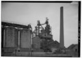 GENERAL VIEW OF BATCH PLANT, CONVEYOR AND GLASS FURNACE STACK LOOKING NORTHEAST FROM DREY STREET - Chambers Window Glass Company, Batch Plant, North of Drey (Nineteenth) Street, HAER PA,65-ARN,1A-1.tif