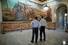 Kansas Governor Sam Brownback (left) and U.S. Secretary of Education Arne Duncan observe John Steuart Curry's Tragic Prelude in the second floor rotunda Kansas Governor Sam Brownback (left) and U.S. Secretary of Education --Arne Duncan observe a mural at the Kansas State Capitol in 2012.jpg