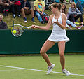 Katy Dunne competing in the first round of the 2015 Wimbledon Qualifying Tournament at the Bank of England Sports Grounds in Roehampton, England. The winners of three rounds of competition qualify for the main draw of Wimbledon the following week.