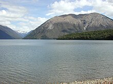 Lake Rotoiti and Mount Robert, snow-covered mountains of St Arnaud Range in the distance Lake Rotoiti and Mount Robert.jpg