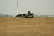 Leclerc tank in a hull-down position. Note the observation periscope which would allow the commander to observe in turret-down position. Leclerc-openphotonet PICT5995.JPG