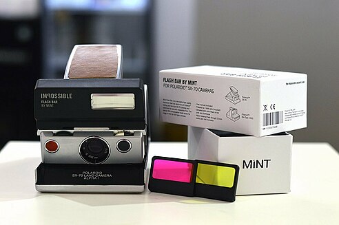 The MiNT Flash Bar with its original packaging, shown here attached to a Polaroid SX-70. MiNT Flash Bar.jpg