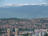 Bjelašnica Mt. (snow peaks, background) with Igman Mt. (foreground, dark-green below snow peaks), to SW.