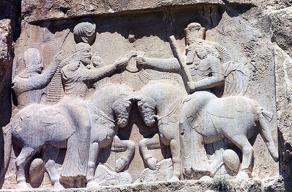 Ahura Mazda (on the right, with high crown) presents Ardashir I (left) with the ring of kingship. (Naqsh-e Rustam, 3rd century CE)