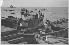 Crates of Jaffa oranges being ferried to a waiting freighter for export, circa 1930 Oranges leaving Jaffa.jpg