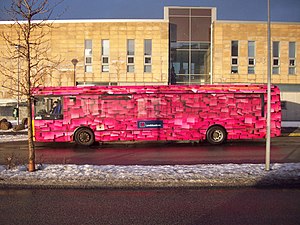 A bus with a full side surface advert. Pink bus.JPG