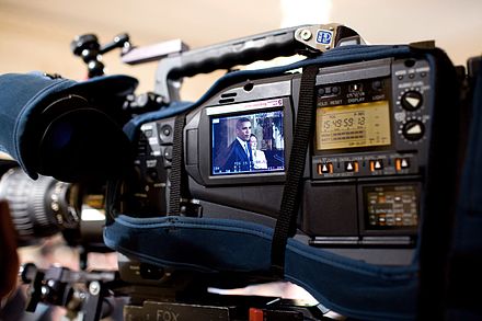 President Barack Obama and Small Business Administration Administrator Karen Mills shown onscreen during an East Room event in the White House in 2009