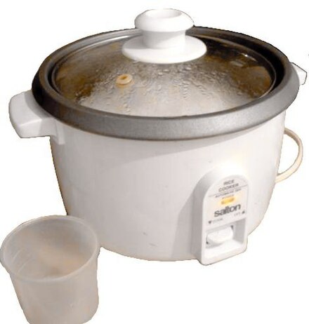 Inexpensive electric rice cooker containing cooked rice