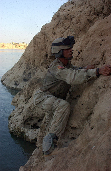 File:SSG Kenworthy from 3rd Platoon B Company, 3rd Battalion, 21st Infantry Regiment, 25th Infantry Division, climbs along a cliff while on patrol along the Euphrates River looking for cashes of weapons in Rawah 050804-A-JL363-043.jpg