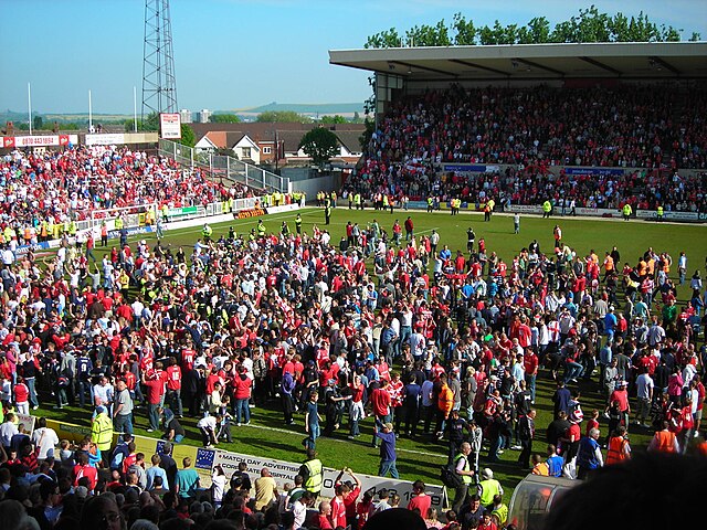 Town fans celebrating promotion on the county ground pitch after the draw with Walsall 2006–07 season