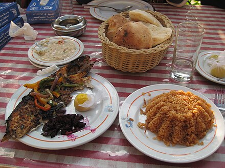 Grilled fish with a side of sayadiya rice