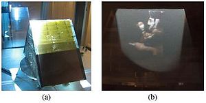 Figure 5: a) two mirrors to show the images in color using cyan filters and orange under the diffusers. b) A color photography of the images that are obtained by this system. Sistema de espejos giratorios 5.JPG