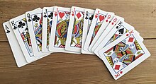 This photo depicts a starting hand for the card game Thirty-Six (with 12 cards). There are three possible combinations playable here, Ace-King-Queen-Jack of Clubs; Jacks of Clubs, Hearts, and Diamonds; and Kings of Clubs, Spades, and Diamonds. There is an incomplete combination of 9-8 of Diamonds. There are two 'duplicate' cards - Queen of Clubs, and Jack of Hearts. Starting hand for Thirty-Six - 12 Cards.jpg