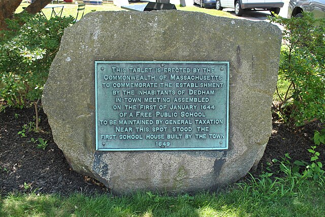 Stone plaque marking the site of the first public school in the United States, located in Dedham, Massachusetts