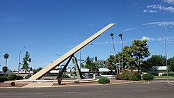 Plaque reads: "Sun City Sundial /One of the largest /Horizontal Sundials in America /Gnomon: 36' high, 64' long /Constructed 1973 /(Renovated 2011)"