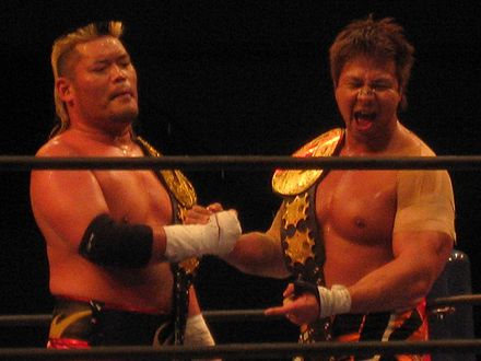 Tenzan (left) and Satoshi Kojima as the IWGP Tag Team Champions in February 2012.