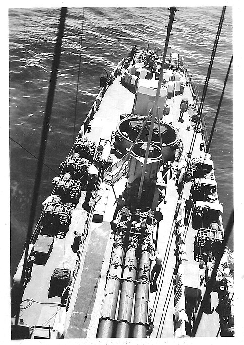 View aft from the mast of Rudderow-class USS Chaffee (DE-230) showing rear 5in and 40mm guns, depth charge racks, depth charge projectors and torpedo 