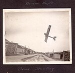 "Armour Heights- 'Some' Stunting" Photograph of aircraft in a steep climb above hangars at Armour Heights. (3569841181).jpg