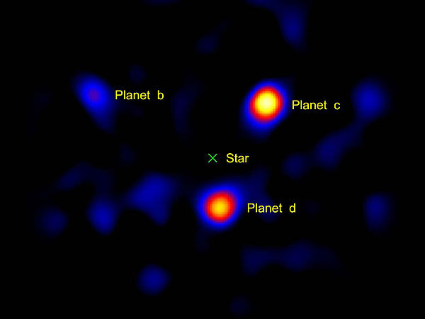 The three known planets of the star HR8799, as imaged by the Hale Telescope. The light from the central star was blanked out by a vector vortex corona