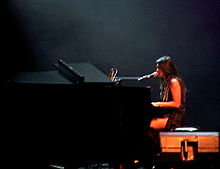 Anggun playing piano during her 2006 concert in Bandung, Indonesia.