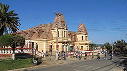 A building made out of stone blocks with a black roof