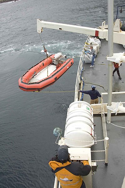 File:Big ship offloads skiff boat.jpg